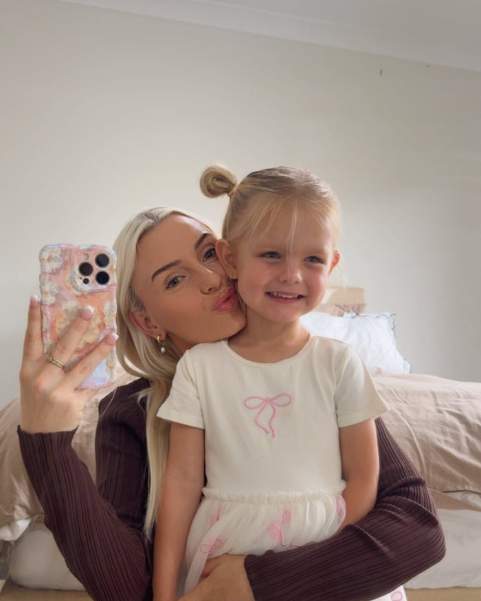 A mother and her young daughter with a floral Bloomy iPhone case